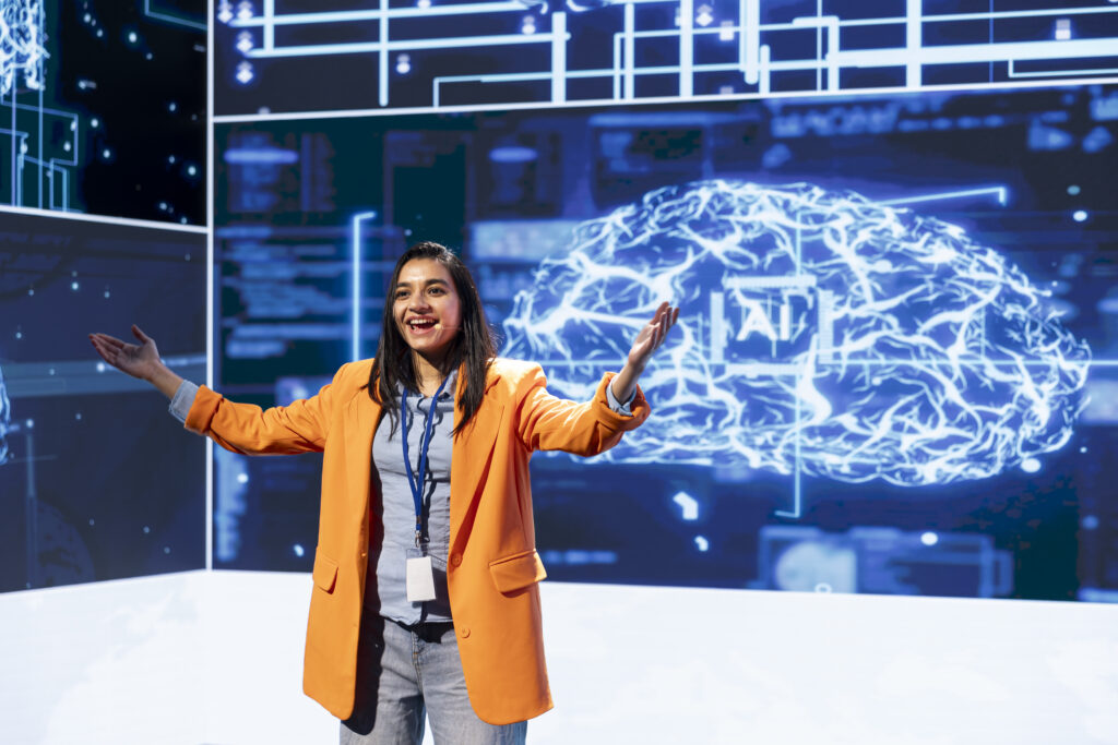 AI expert presenting artificial intelligence solutions on stage with digital brain and data visuals in the background.